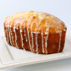 a cake with icing sitting on top of a white plate