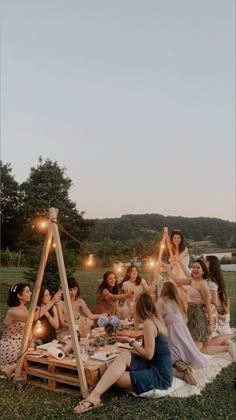 a group of women sitting around a picnic table