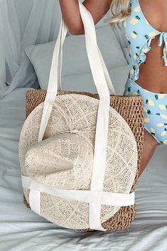 70% PAPER, 30% POLYESTER Color: Tan/Dark Khaki Braided Straw Tote Canvas Straps Can Hold A Wide Brim/Fedora Style Hat On Front Zipper Closure Lined Inner Slip Pocket Dimensions: 18" W x 19" H x 3.5" D Launched: 2/27/24 Casual Neutral Beach Bag For Spring, Beige Straw Hat For Beach Vacation, Beige Summer Straw Hat For Beach Season, Beige Straw Hat For Vacation Beachwear, Beige Beachwear Straw Hat For Vacation, Summer Beige Straw Hat For Beach Season, Beachy Beige Straw Hat For Beach Season, Beige Straw Hat For Vacation, Beachwear Beige Straw Hat For Beach Season