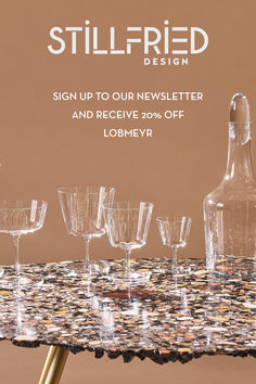 a table topped with lots of glasses next to a bottle and glassware on top of it