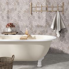 a white bath tub sitting next to a towel rack