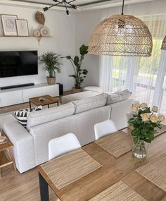 a living room filled with furniture and a flat screen tv mounted to the side of a wall