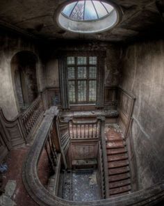 an old staircase with a skylight above it