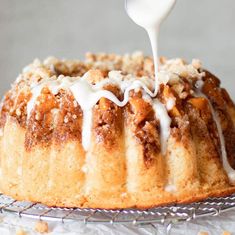 a bundt cake is being drizzled with icing