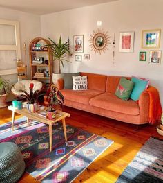 a living room filled with furniture and lots of pictures hanging on the wall above it