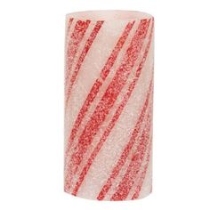 a red and white striped candle holder with glittery stripes on the inside of it