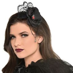 Top off your gothic look with the perfect accessory. This black flower hairclip features an intricate lace extension on top a silver and red spider charm in the center and layered black chains that hang just below along with a black teardrop gem.Black Lace Satin & Velour Flower Hairclip with Spider & Chains product details:7in wide x 8in longChain gemstone lace and spider detailsAttached alligator clipMaterials:Lace and flower: polyesterChain: metalGem: plasticSpider: metalClip: metalCar Black Hair Clips, Red Spider, Gothic Looks, Halloween Store, Halloween Costume Accessories, Adult Halloween Costumes, Black Flower, Black Chain, Long Chain