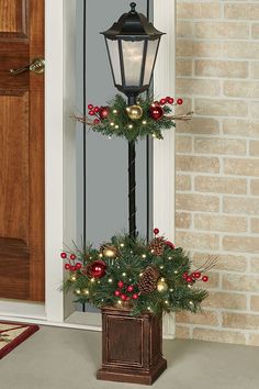 a lamp post decorated with christmas decorations and lights