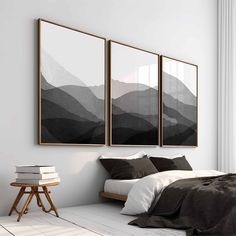 two paintings hanging on the wall above a bed