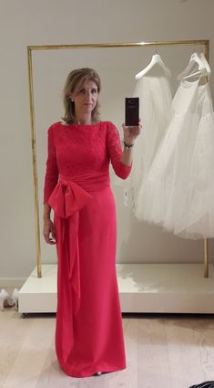 a woman in a red dress taking a selfie