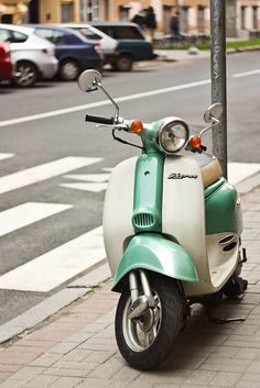 a scooter is parked on the side of the street