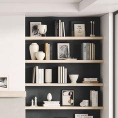 a living room filled with lots of books on top of wooden shelves next to a fire place