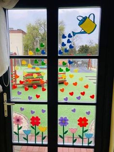 an open door with flowers and watering can on the window sill in front of it