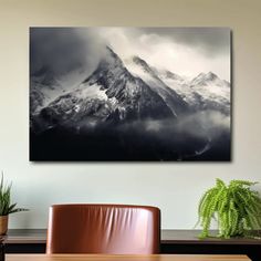 a table and chair in front of a large mountain