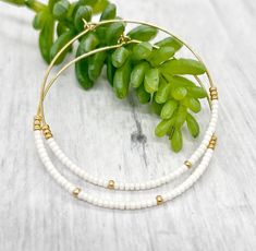 White hoop earrings, beaded hoop earrings, dainty bead hoop earrings, dangle gold earrings, big hoop earrings, hoop earrings, gold hoop These hoop earrings are so chic to show off your style by wearing them with your hair tucked or low in bun. They are perfect for daily wear in the office or a night on the town.  Earrings are enlarge to show details and colors might vary depend on each computer monitor or cell phone screen.  Each piece will be a unique one of a kind treasure. White 14k Gold Filled Hoop Earrings, White 14k Gold Filled Hoop Jewelry, Dainty White Hoop Jewelry, Small Hoop Gold Beaded Jewelry, Everyday Hoop Beaded Earrings With Ear Wire, Beaded 14k Gold Filled Hoop Earrings, Handmade White 14k Gold Filled Hoop Earrings, Dainty Everyday Earrings With Tiny Beads, Handmade 14k Gold Filled White Hoop Earrings