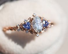 an engagement ring with blue and white stones