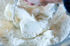 someone mixing ingredients in a glass bowl