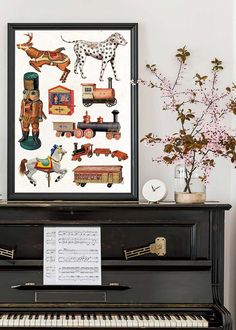 there is a piano and some pictures on the wall