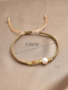 the gold beaded bracelet with pearls is shown on a beige fabric background, and measurements are