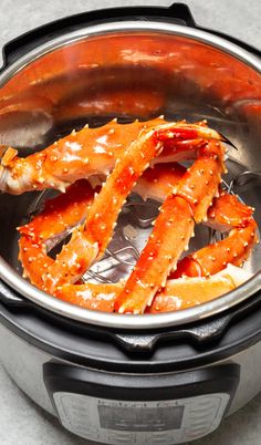 cooked crab legs in an instant pot on the stove top, ready to be cooked