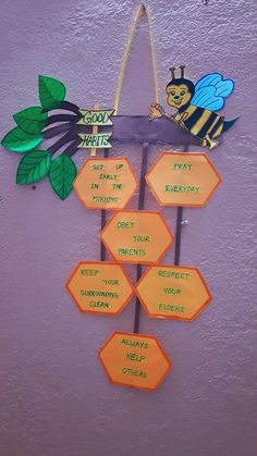 a bulletin board with some writing on it and a bee sitting on top of the sign