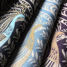 several different colored and patterned fabrics are shown in close up view, including blue, black, gold and white colors