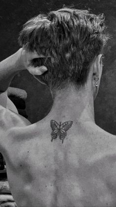 a man with a butterfly tattoo on his back