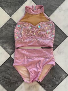 a woman's pink swimsuit with sequins on it