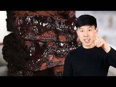 a man pointing at a pile of brownies