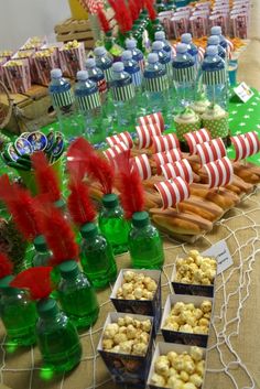 a table filled with lots of food on top of a table covered in green bottles