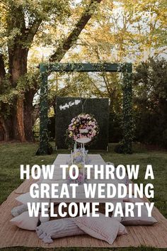 a table with pillows and flowers on it in the middle of a grassy area that says how to throw a great wedding welcome party