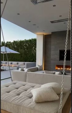 a living room filled with white furniture and a fire place in the back ground area