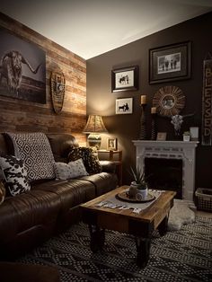 a living room filled with furniture and pictures on the wall