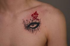 a man with an eye tattoo on his chest