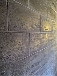 a close up of a brick wall with light shining on it