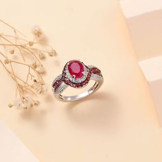 This vibrant gemstone ring features a dazzling centerpiece, encircled by a luminous halo of multi-gemstone accents. Expertly crafted in sterling silver, it embodies timeless elegance and modern flair. This silver ring is perfect for adding a touch of radiant sophistication to any ensemble.       Details          Halo symbolizes eternal love and commitment Adorned with a vibrant gemstone centerpiece  Encircled by a dual halo of contrasting gems for striking brilliance Prong set oval and round-shaped stones for maximum sparkle Interwoven design shank enhances the sophisticated allure Crafted in sterling silver for durability Hypoallergenic, suitable for sensitive skin Eternal Love, Mozambique, Gemstone Ring, Prong Setting, Timeless Elegance, Silver Ring, Sensitive Skin, Halo, Ruby