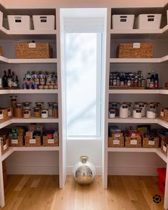 an empty pantry with lots of shelves and bins on the wall next to it