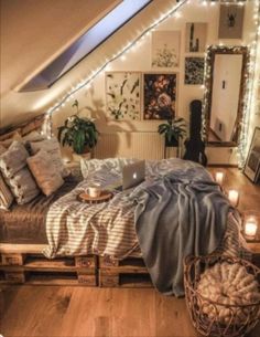 a bed with blankets and pillows in a room filled with lights on the ceiling, surrounded by wooden crates