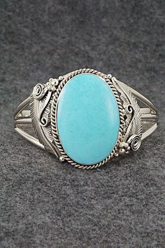 This stunning turquoise and sterling silver bracelet was made by Navajo silversmith Glen Smith. The back is partially signed RB and .925. Size: 5 1/2" (will fit up to a 6 1/2" wrist) Gap: 1" Width: 1 5/8" Cuff Width: 3/8" Free shipping on all orders! We ship with USPS and always include tracking. All orders ship within a day of payment. Returns are accepted up to 30 days after you receive your order. Just send us a message. Our shop offers cash back or store credit. The item must be returned in Elegant Sterling Silver Bracelet With Turquoise, Western Style Blue Sterling Silver Bracelet Gift, Bohemian Oval Sterling Silver Bracelet, Elegant Engraved Turquoise Sterling Silver Bracelet, Elegant Turquoise Engraved Sterling Silver Bracelet, Bohemian Sterling Silver Oval Cuff Bracelet, Collectible Bohemian Blue Sterling Silver Bracelet, Bohemian Oval Sterling Silver Cuff Bracelet, Southwestern Oval Sterling Silver Cuff Bracelet