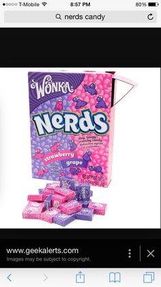 a box of nerds sitting on top of a pile of pink candies in front of a white background