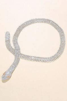 Adorn yourself with a serpent-shaped water diamond necklace, an embodiment of timeless allure. Crafted with intricate detail to enhance your elegance, perfect for adding a touch of sophistication to any ensemble. Elegant Snake Shape Necklaces With Clavicle Chain, Elegant Snake Clavicle Chain Necklaces, Formal Snake-shaped Diamond Jewelry, Formal Diamond Snake Jewelry, Silver Jewelry With Diamond Eyes For Party, Elegant Snake-shaped Jewelry With Diamond Accents, Elegant Clavicle Chain Necklace With Snake Shape, Snake-shaped Diamond Jewelry For Wedding, Elegant Snake Shape Necklace For Party