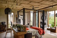 a bedroom with stone walls and ceiling fan