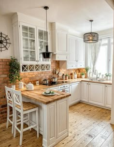 a kitchen with wooden floors and white cabinets