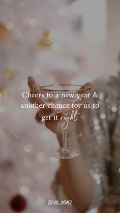 a woman holding a wine glass in her hand with the words cheers to a new year & another chance for us to get it right