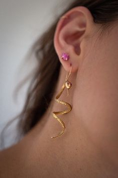 Inspiration for our Ophidian Earrings was born from the discovery of a woven wire snake wrapped around a vintage perfume bottle. We pushed the snake towards realism by adding a coiled shapeliness to its body, tapered tail, a moving tongue, precious stone eyes and finished off the design with locking ear wires. The pair of snakes spiral in opposite directions, a mirror image of each other. Snakes have long been a subject of great interest and symbology in our history. A point of contention, obses Wire Snake, Snake Jewelry, Vintage Perfume Bottles, The Snake, Vintage Perfume, Perfume Bottle, Ear Wire, Stone Settings, Cute Jewelry