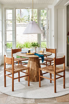 a dining room table with four chairs around it