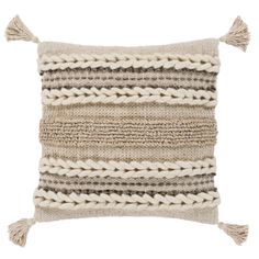 a beige and black striped pillow with tassels on the front, in two different colors