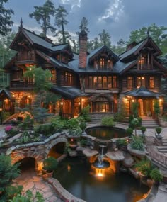 a large house with a pond in front of it and lots of lights on the windows