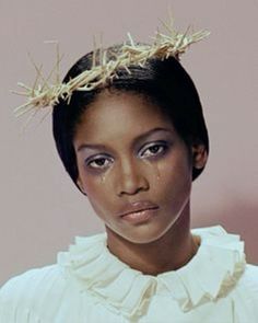 a woman wearing a crown of sticks on her head