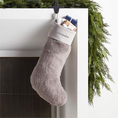 a christmas stocking hanging from the side of a fireplace